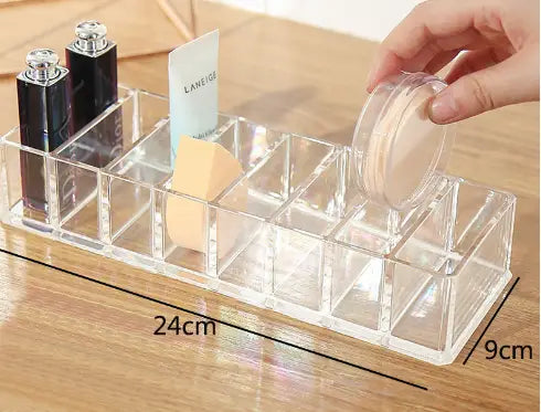Clear acrylic makeup organizer with multiple compartments holding cosmetics and a sponge in a makeup organizer image.