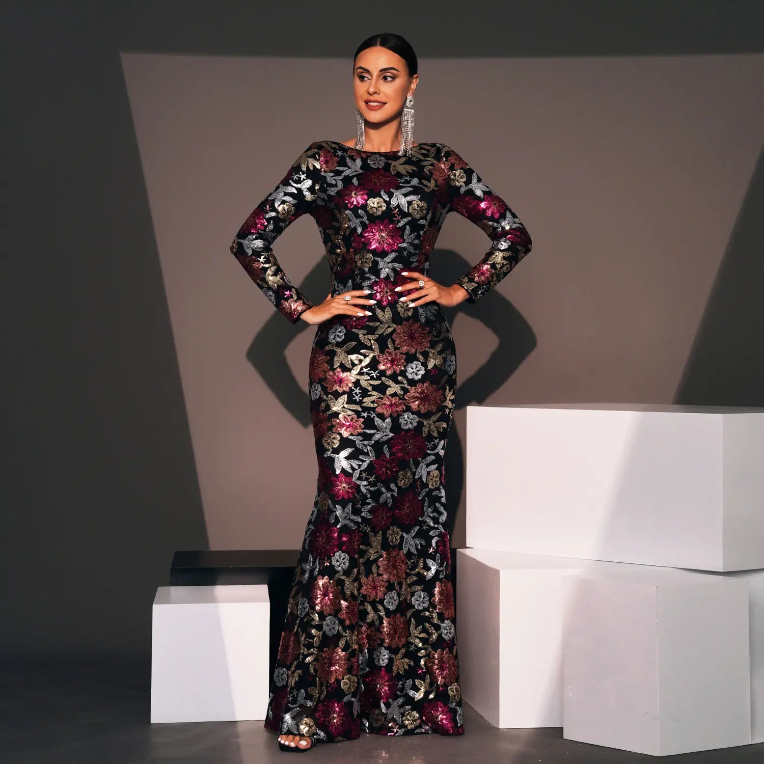 A black evening gown long sleeve with intricate burgundy and metallic gold floral embroidery designed for formal occasions.