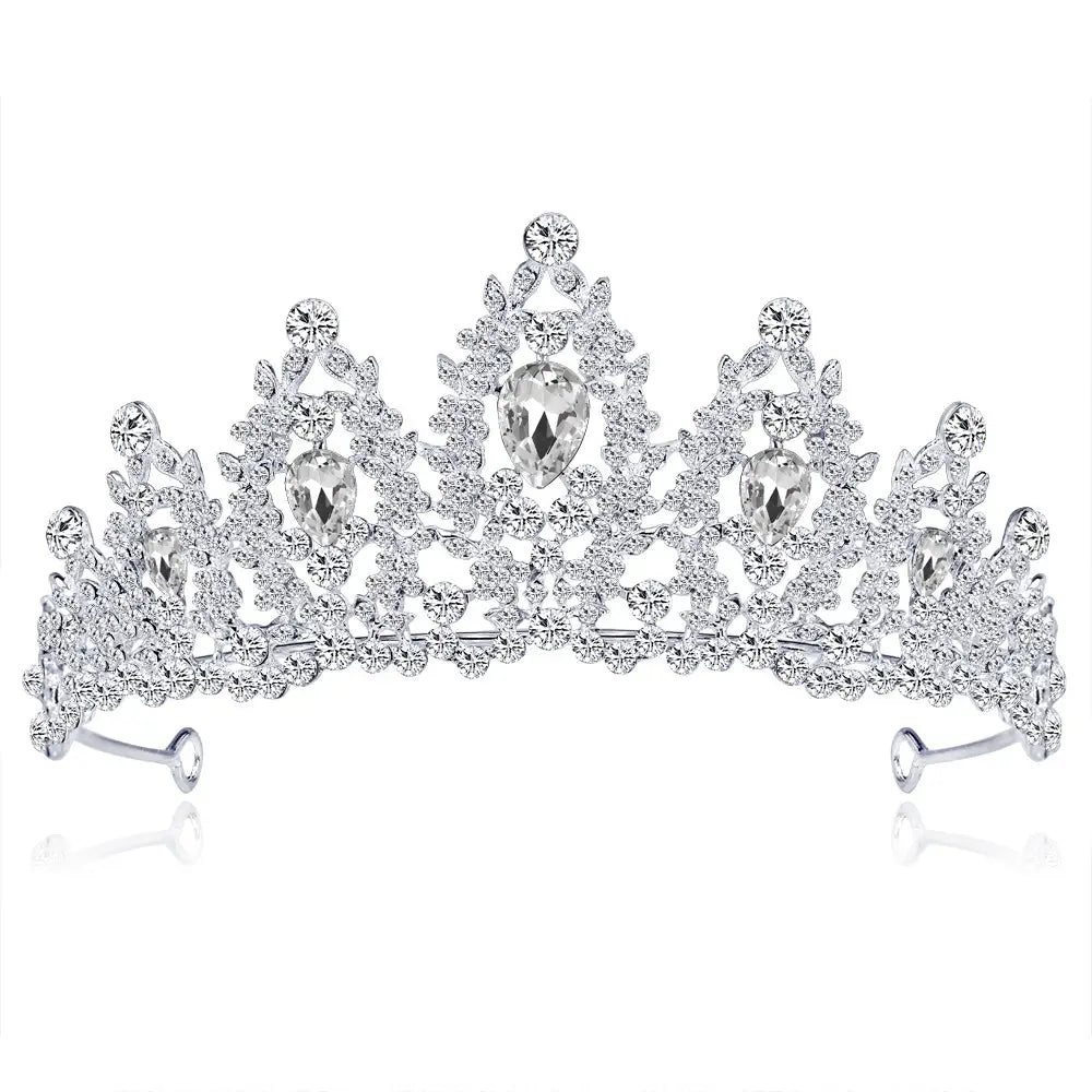 A sparkling silver bridal crown european adorned with intricate crystal embellishments and larger pear-shaped teardrop crystals.