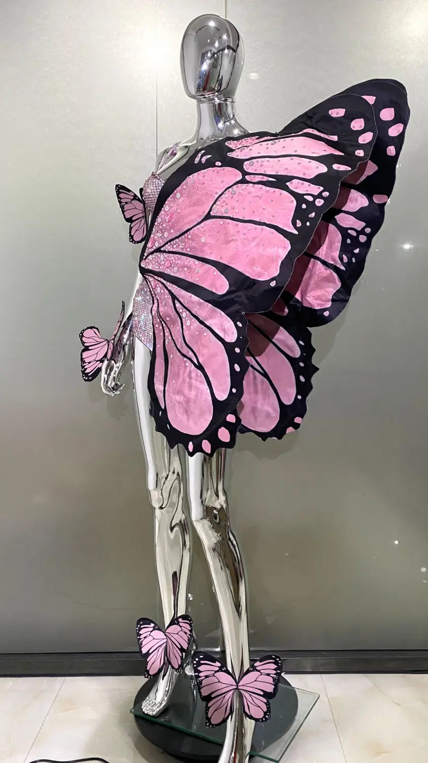 sequin butterfly latin dance skirt dress with pink and black butterfly wings displayed on a chrome mannequin featuring net yarn stretch fabric ideal for latin dance.