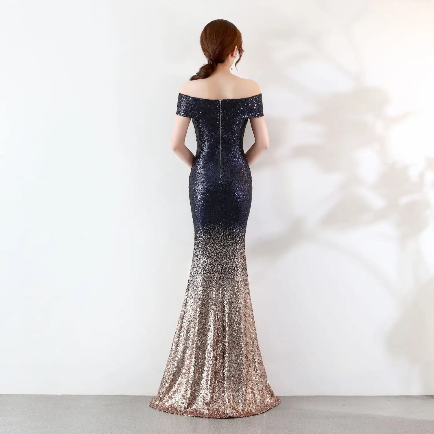 A shimmering off-the-shoulder mermaid birthday party dress with a black-to-gold sequin gradient, featuring a fitted bodice and flowing skirt ideal for dress slimming host occasions.