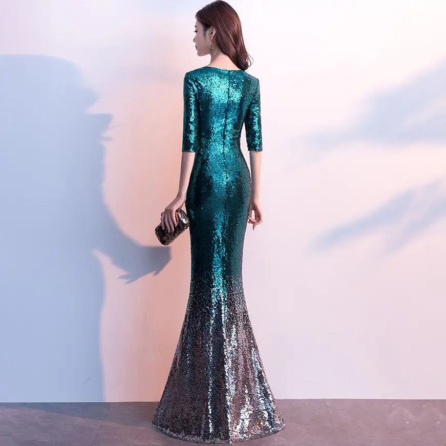 Emerald green sequined annual meeting gown made of polyester fiber with three-quarter sleeves and a gradient to silver at the hem.