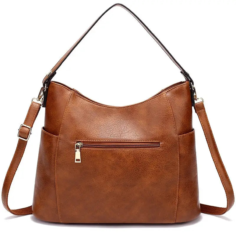 Brown large capacity luxury women leather hobo bag made of faux leather with a single shoulder strap, adjustable crossbody strap, and front zippered pocket.