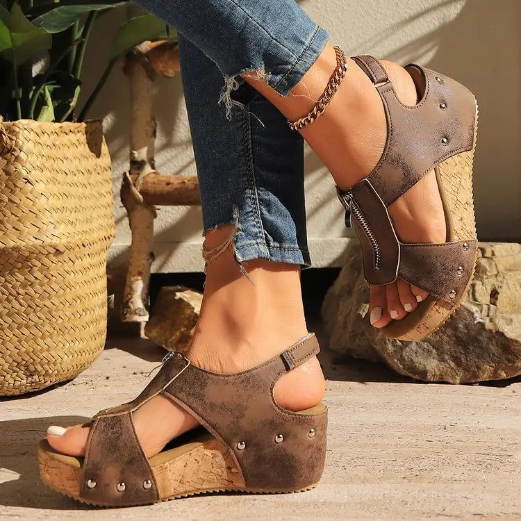 Brown suede zipper wedges sandals with cork soles and silver studs offering lightweight height increasing for summer wear.