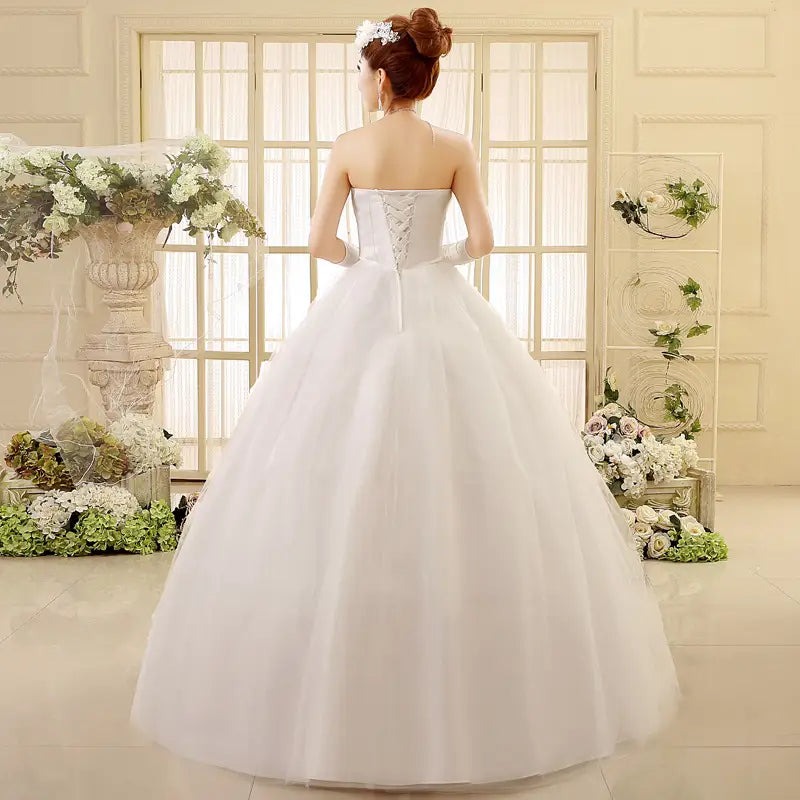 a korean style tube top lace wedding dress featuring a strapless white gown with a fitted bodice and voluminous tulle skirt