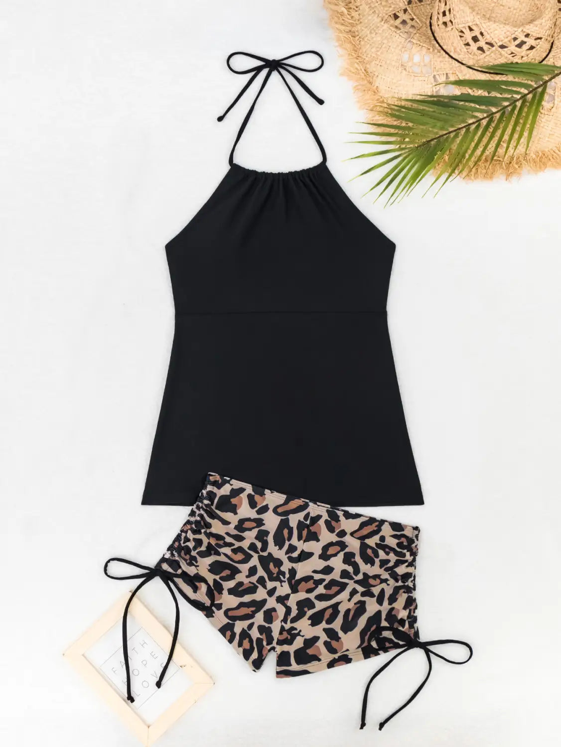 black halter top with adjustable tie straps paired with leopard print shorts featuring a flattering fit in a floral halterneck printed halter split swimsuit design.