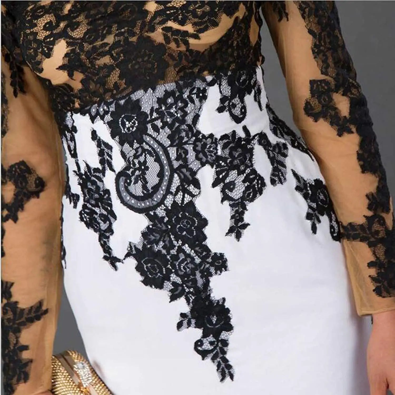 black lace slim mermaid tail wedding dress with intricate floral lace bodice and skirt featuring sheer tan sleeves.