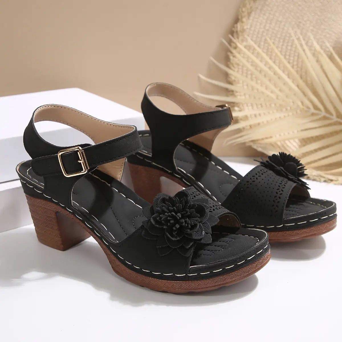 Black suede chunky heel sandals with floral embellishment and wooden block heels ideal for heel sandals summer.