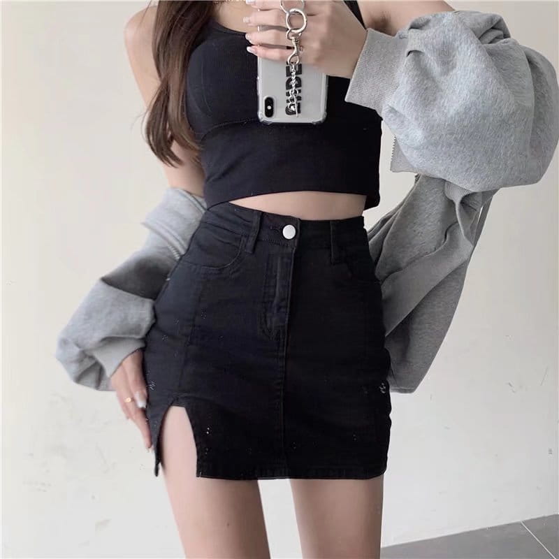 black high-waisted distressed denim skirt with side slit and front button closure in black denim material