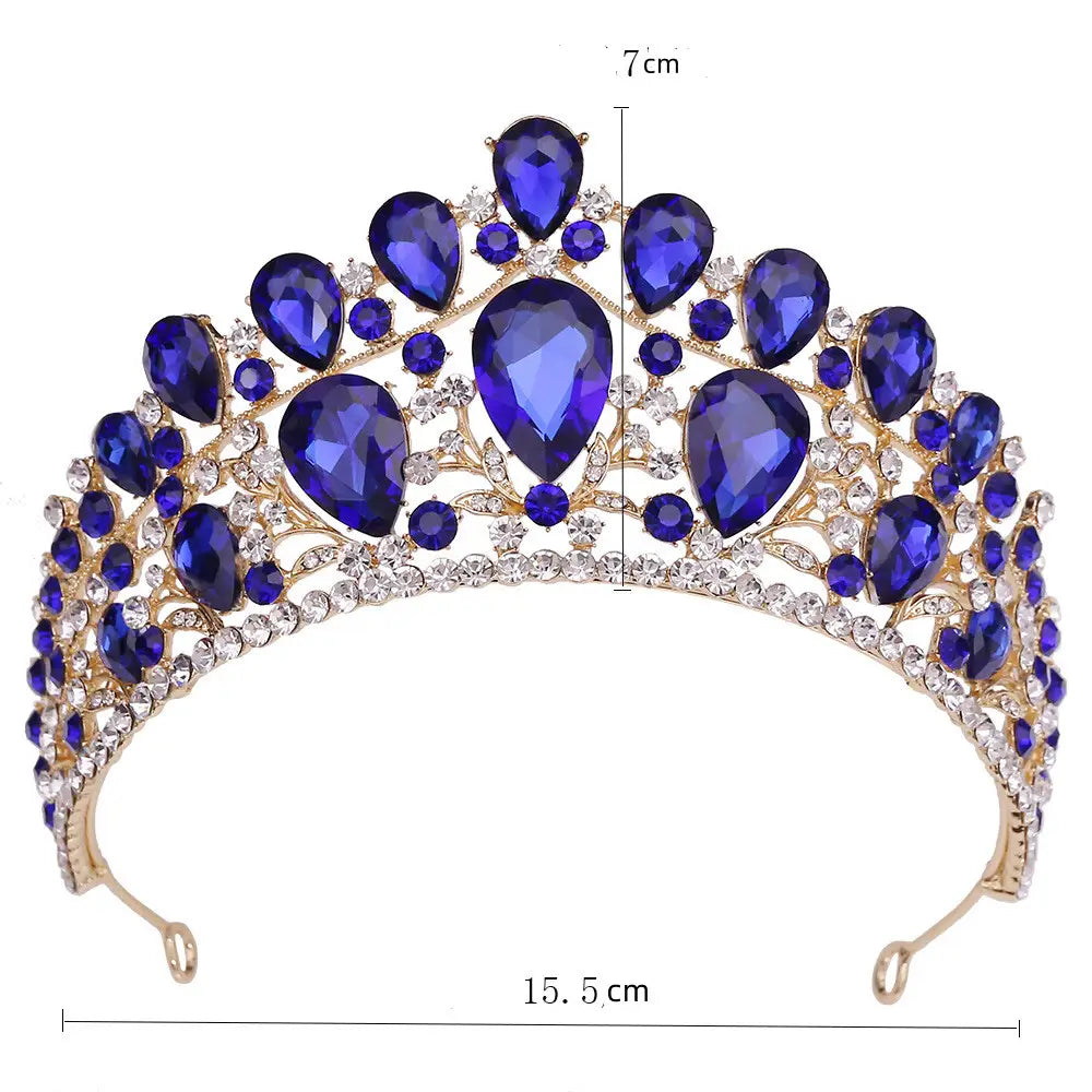 A royal blue and clear crystal fashion bridal knot tiara with a gold-tone metal base for elegant bridal wear.