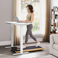 White standing desk treadmill with wood walking pad featuring a 5hp motor and shock-absorbing belt in use
