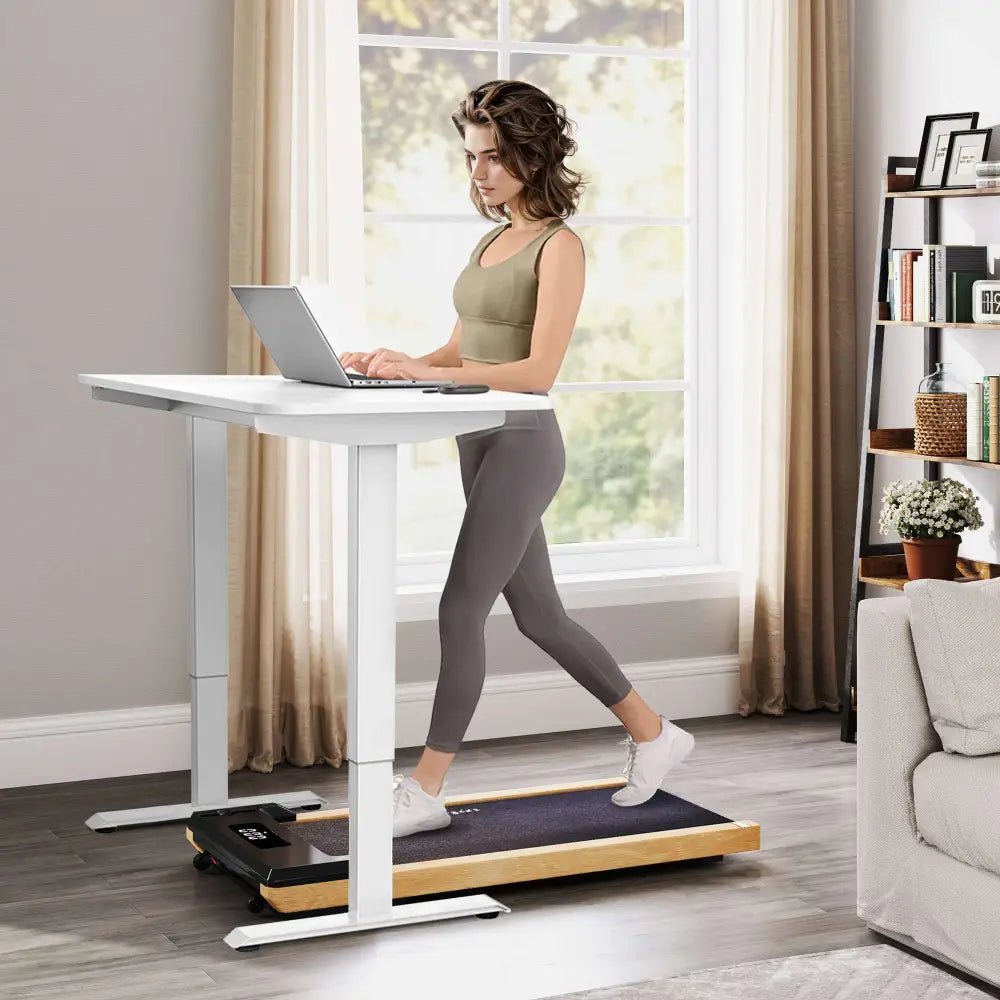 White standing desk treadmill with wood walking pad featuring a shock-absorbing belt and 2.5hp motor in use