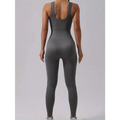 Back view of a sleek gray ribbed one-piece casual wear jumpsuit with waist curve cutout in a pack ribbed solid design