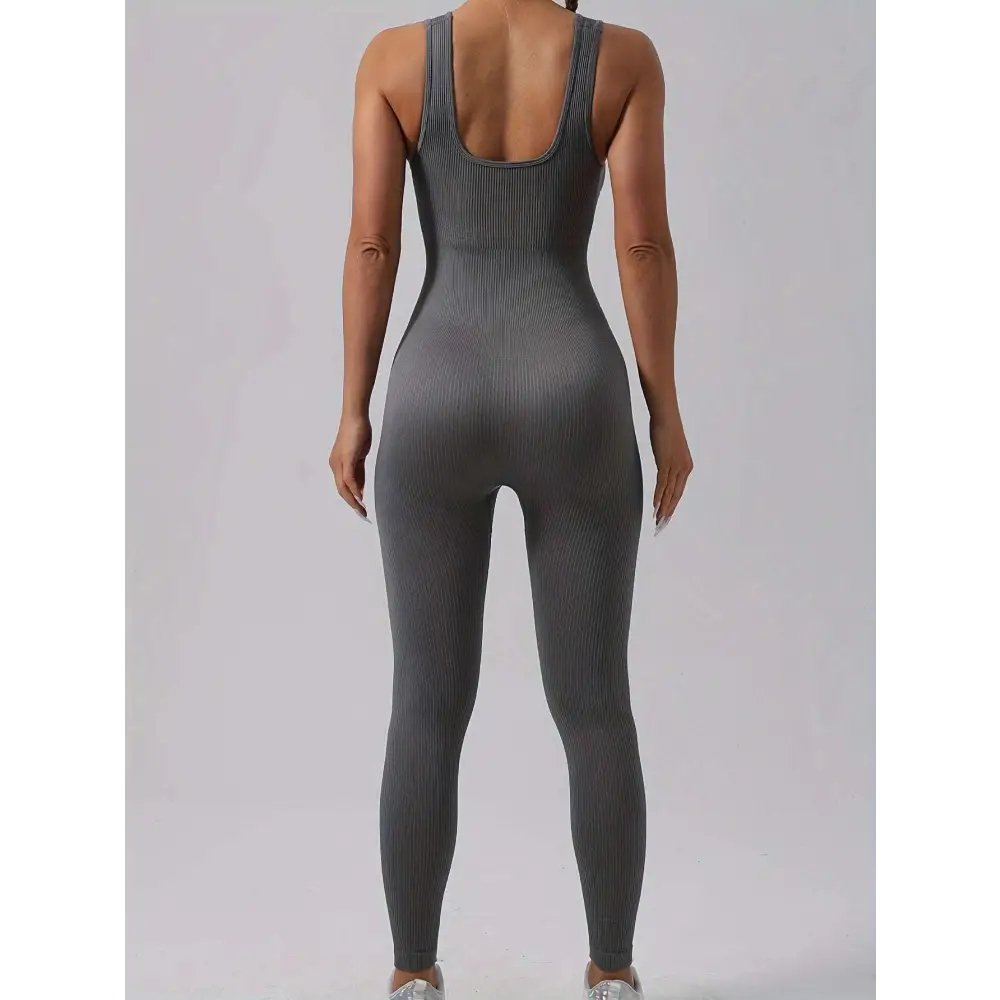 Back view of a sleek gray ribbed one-piece casual wear jumpsuit with waist curve cutout in a pack ribbed solid design