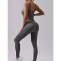 Back view of charcoal gray ribbed one-piece casual wear jumpsuit with waist curve and thin shoulder straps in pack ribbed solid