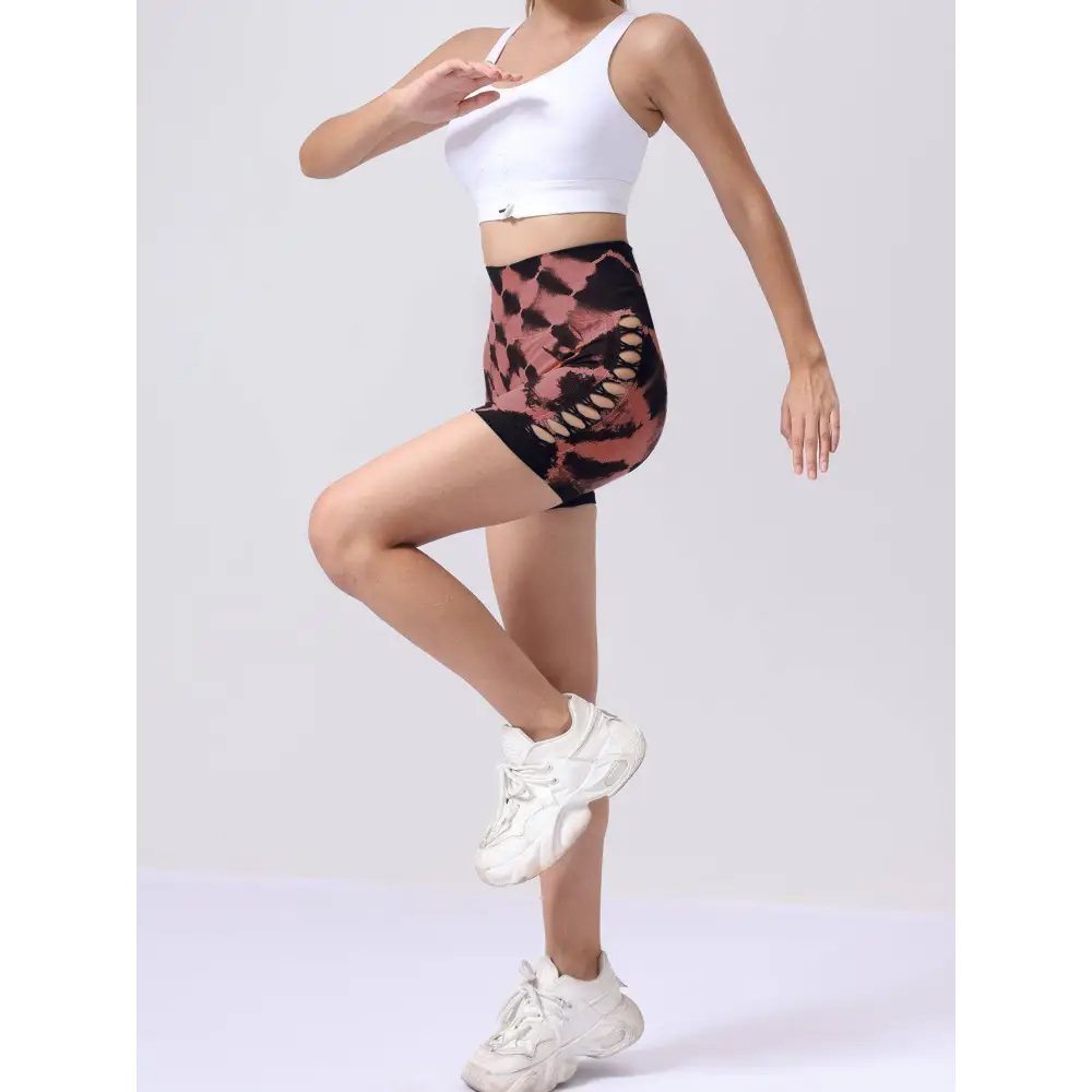 High-waist seamless athletic shorts in bold pink and black pack tie dye featuring cut-out details and seamless hip lift design