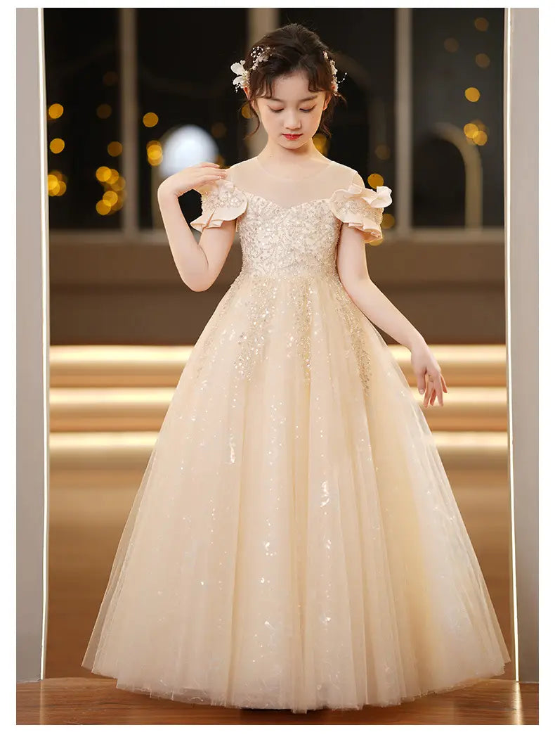 A delicate off-the-shoulder champagne sequined spandex princess dress for girls featuring sparkling embellishments and ruffled tulle tutu sleeves.