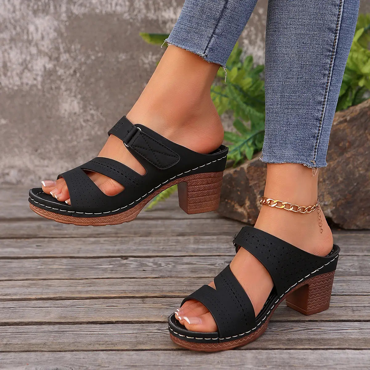 Black perforated strap mules with textured brown block heel and white stitching are stylish shoes summer casual ideal for summer casual chunky wear.