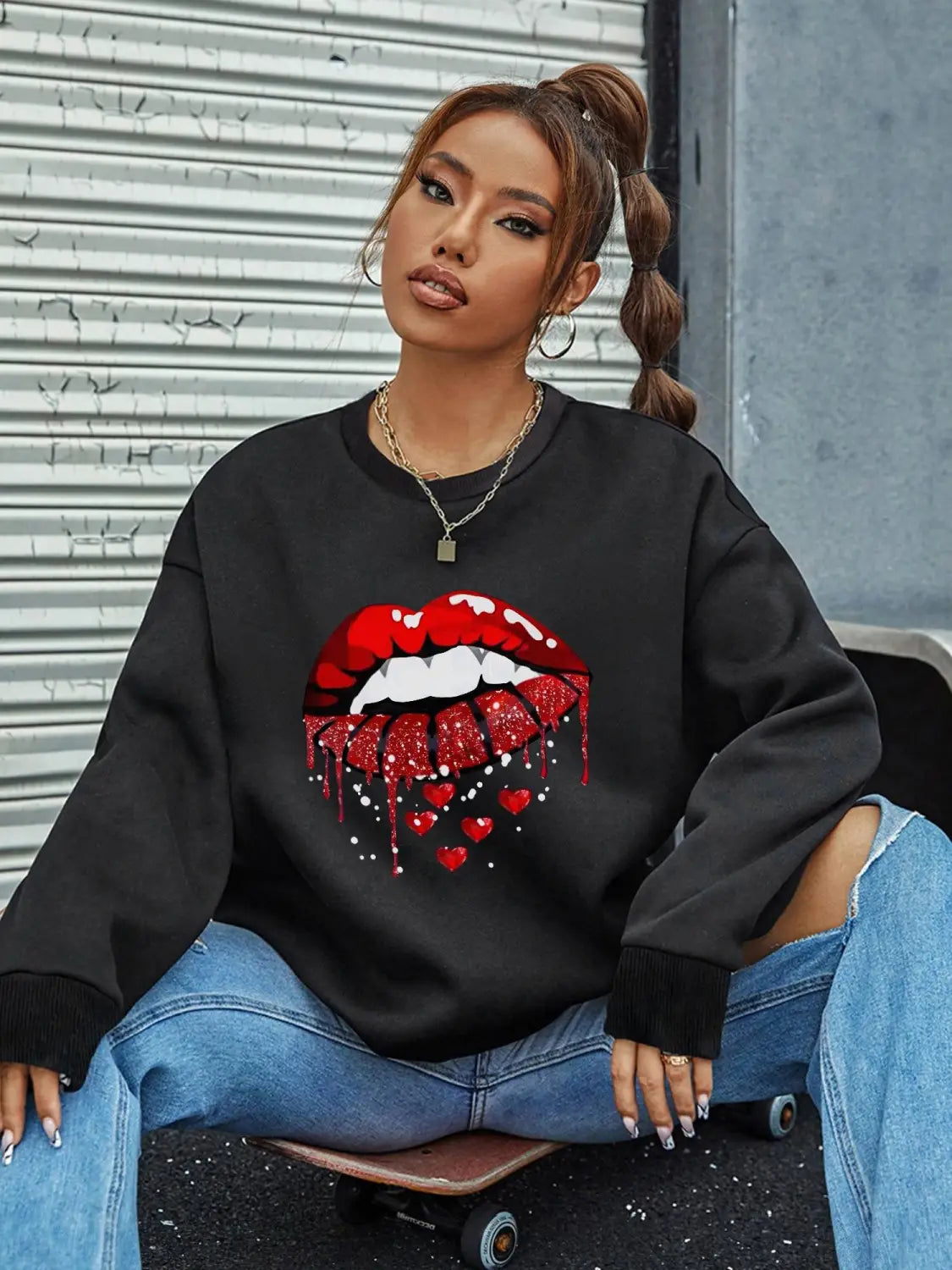 black oversized pocketed long sleeve sweatshirt featuring a bold red glittery lips graphic with dripping hearts