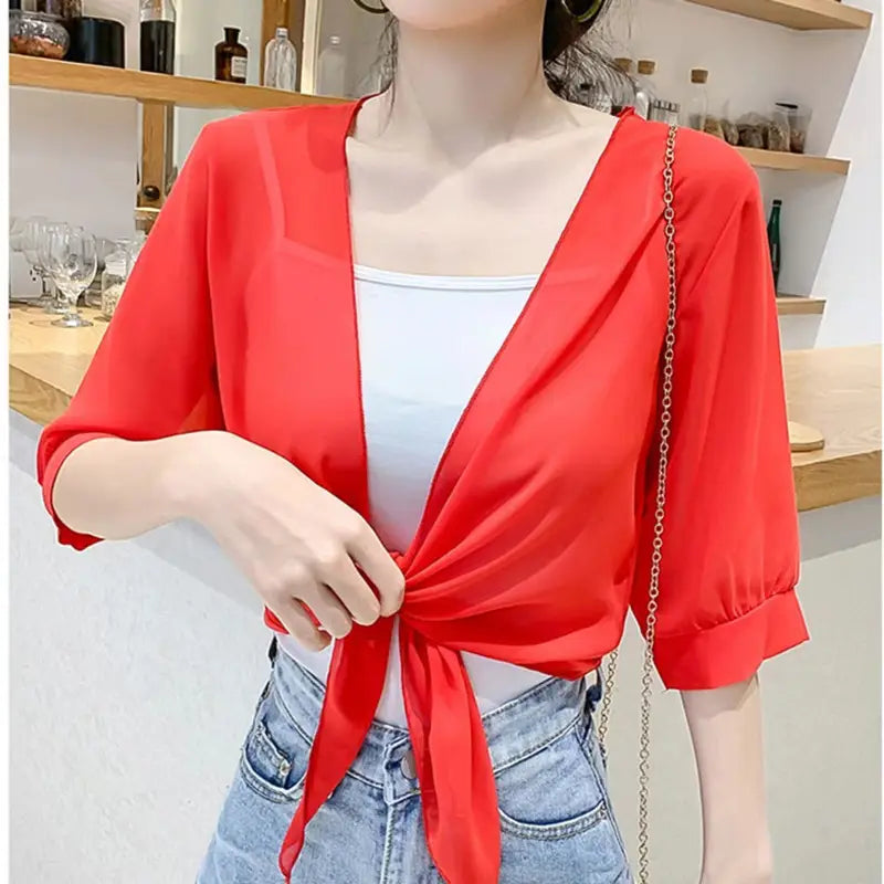 vibrant red sheer chiffon wrap top with three-quarter sleeves and tied front knot designed as a short shawl summer coat for sun protection.
