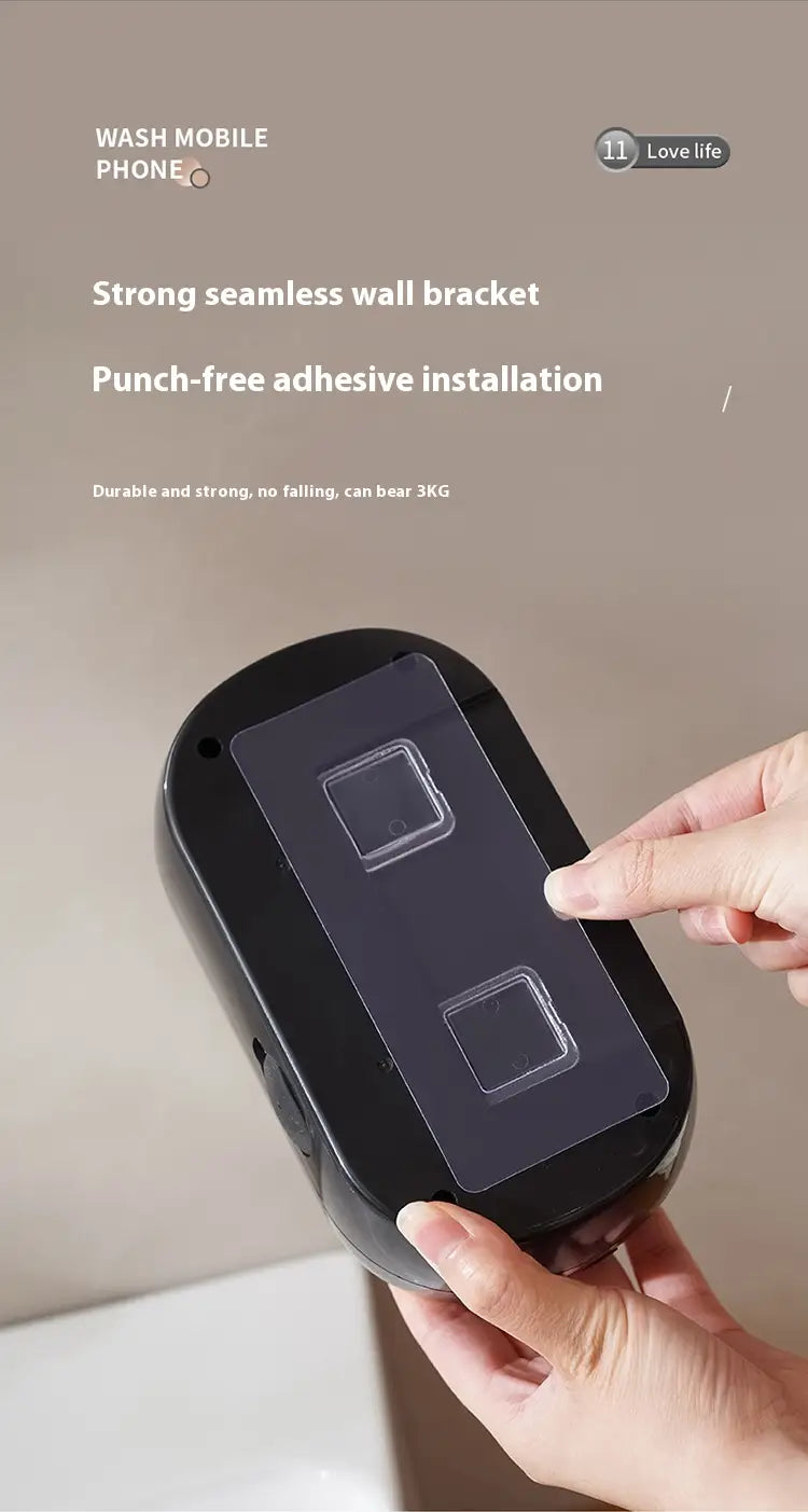 black oval-shaped wall bracket with transparent adhesive pads for punch-free installation of a black rose gold bathroom automatic intelligent foam soap dispenser.