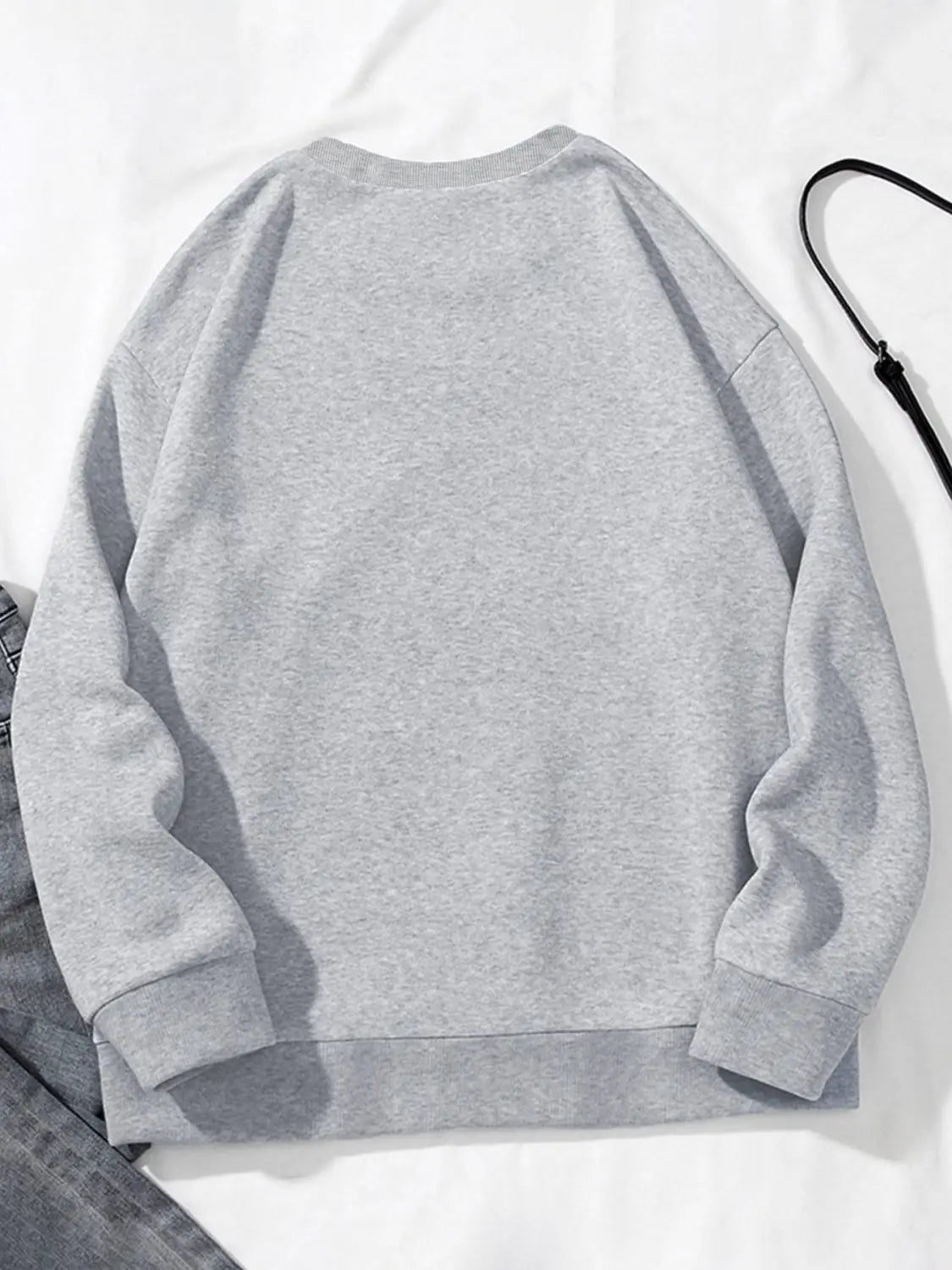 a soft heather gray pocketed long sleeve sweatshirt with a relaxed fit and ribbed cuffs featuring white glitter lips design
