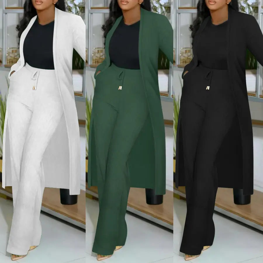 a plus-size woman wearing a white green and black long cardigan sunken stripe set featuring a flowing coat and matching wide-leg pants