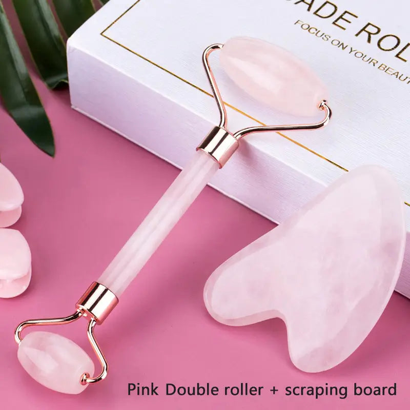pink rose quartz facial roller and gua sha wrinkle remover gua with gold-toned metal accents and matching pink stone scraping board