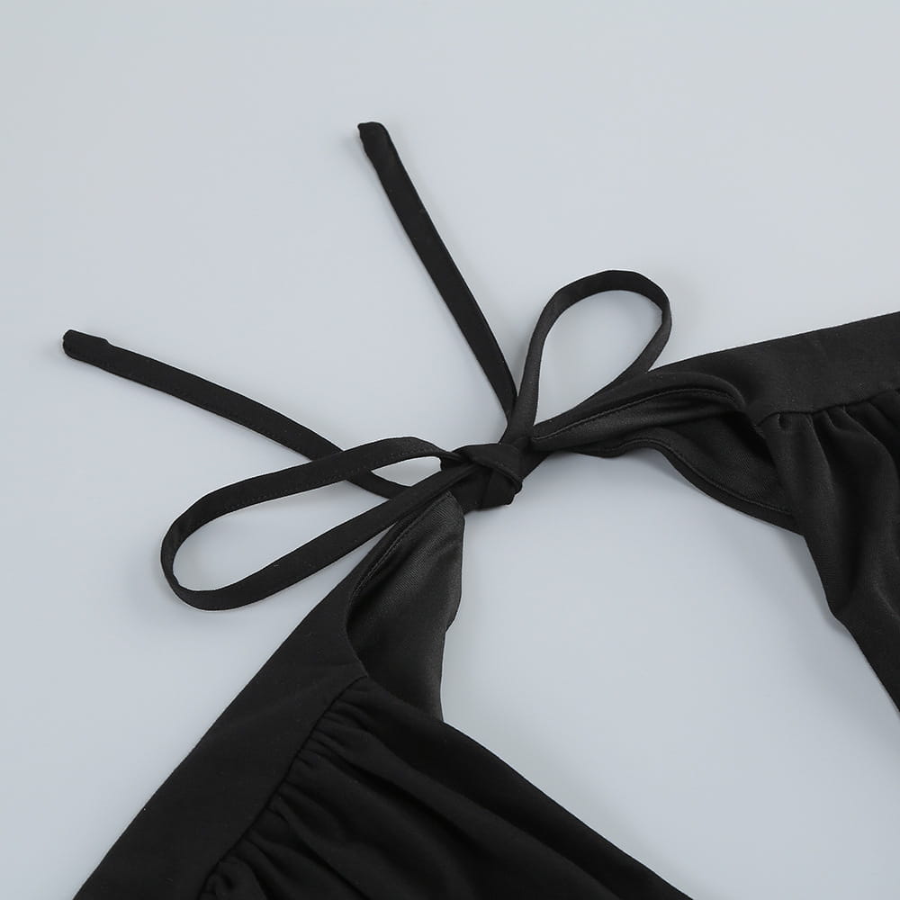 black satin halter top with a tied bow at the neckline paired with a black v neck backless long sleeves skirt waist gown
