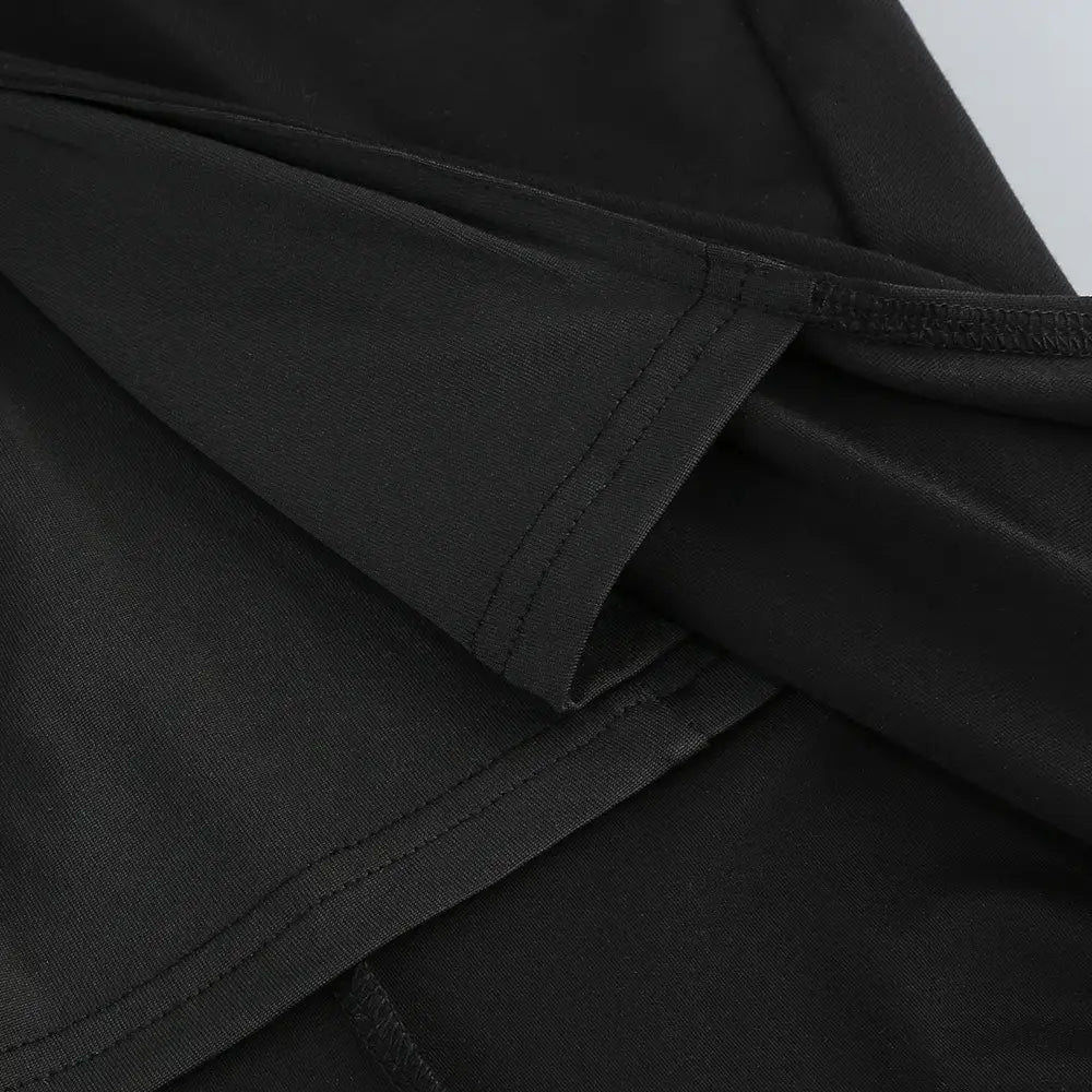 black cotton fabric with neat stitched seams of a backless long sleeves skirt waist gown