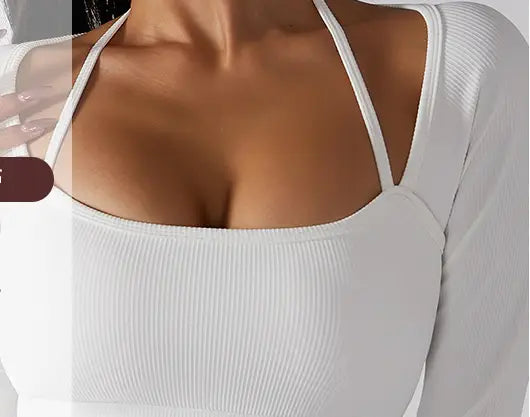 White ribbed long sleeve top with thin shoulder straps featuring chest pad slim fit design for yoga and activewear.
