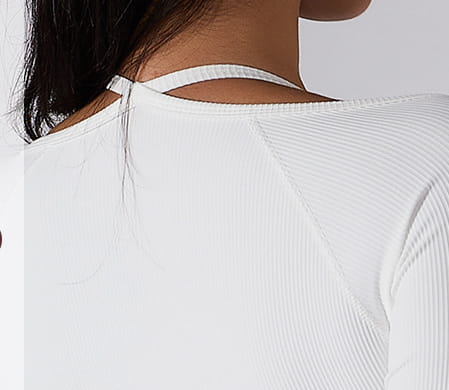 white ribbed long sleeve top with thin shoulder straps featuring chest pad slim fit for yoga and activewear.