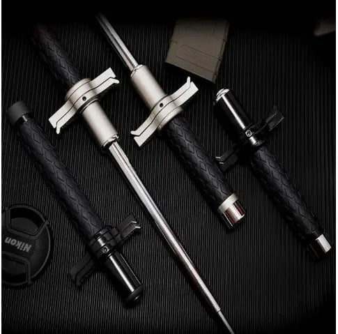 Black and silver telescopic self-defense anti-cut stick featuring a textured grip and metallic joints from Royale Essence Lux.