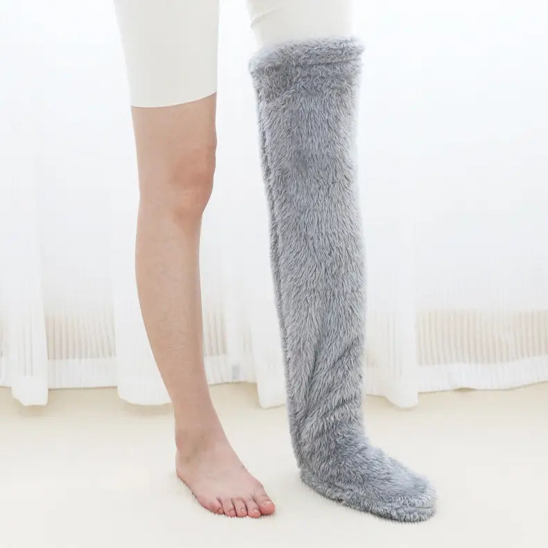 Gray plush faux fur fuzzy long socks worn over the knee featuring a tan paw print design.