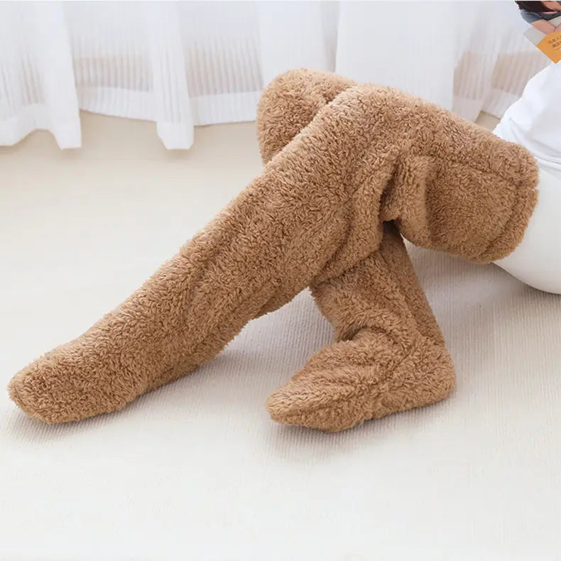 tan plush fleece over-the-knee leggings with a soft textured surface designed as fuzzy long socks featuring a paw print pattern