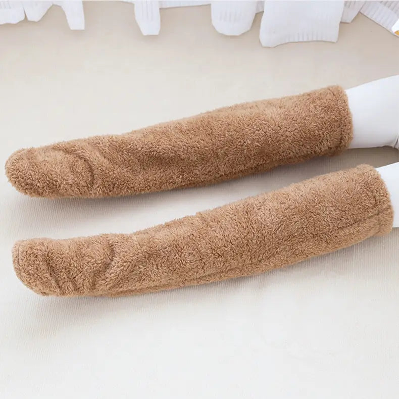 a pair of tan paw print fuzzy long socks with a soft plush texture designed as cozy over-the-knee long socks