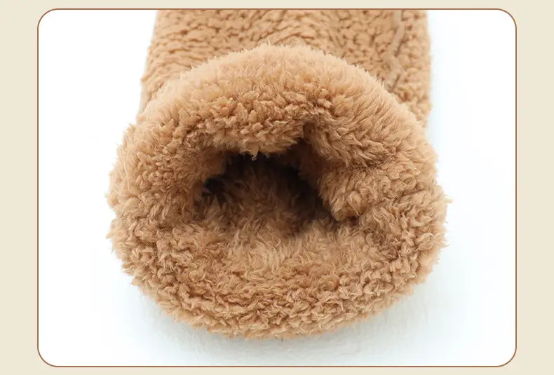 tan plush fleece-lined winter boot cuff on fuzzy long socks featuring a paw print design