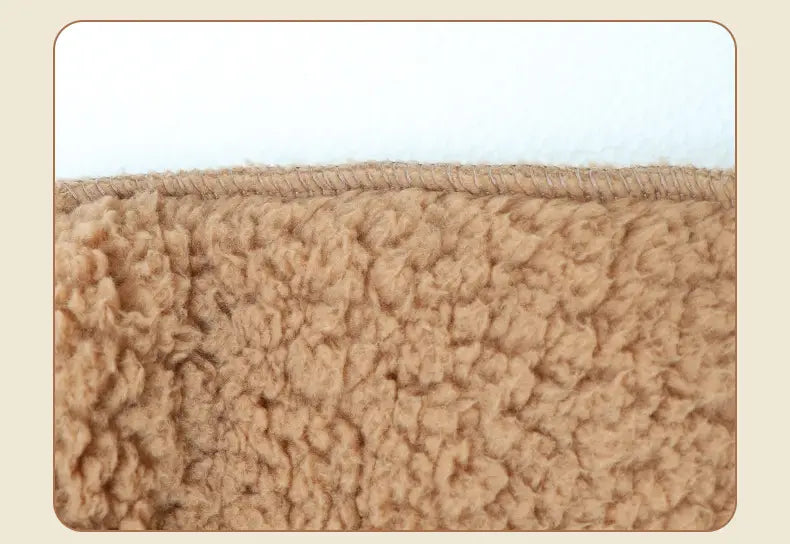 tan paw print fuzzy long socks made of tan plush sheepskin-like fabric with a soft textured surface and neatly stitched edge