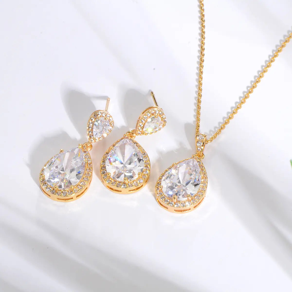 bright big zircon water drops jewelry set featuring a gold-toned teardrop-shaped crystal pendant with matching earrings and chain