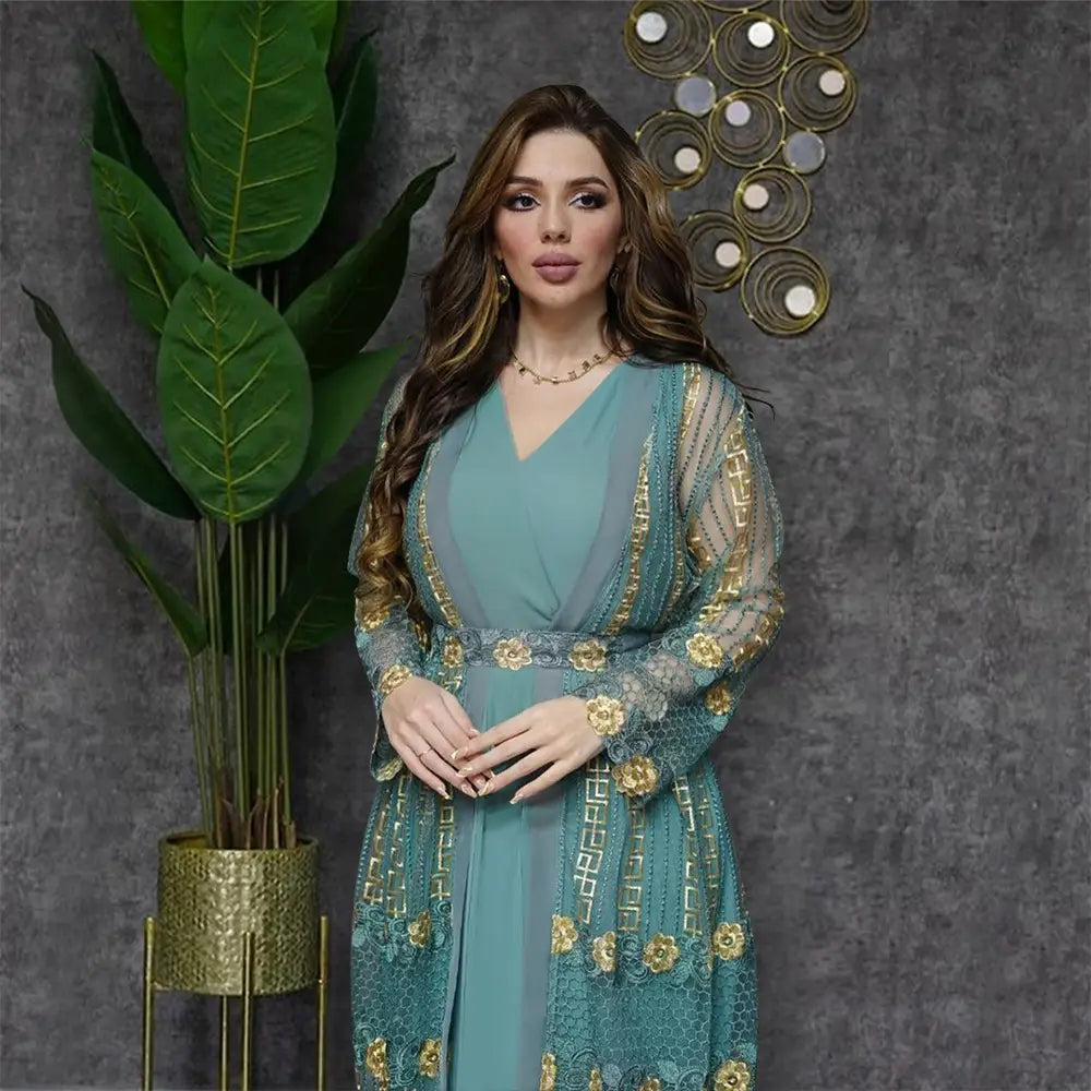 A teal and gold embroidered lace overlay vest dress kraft abaya featuring floral motifs in a sophisticated design.