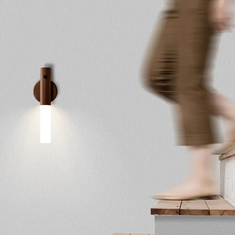 A sleek minimalist wooden led desk lamp sconce with a warm brown finish and frosted glass emitting soft white illumination.