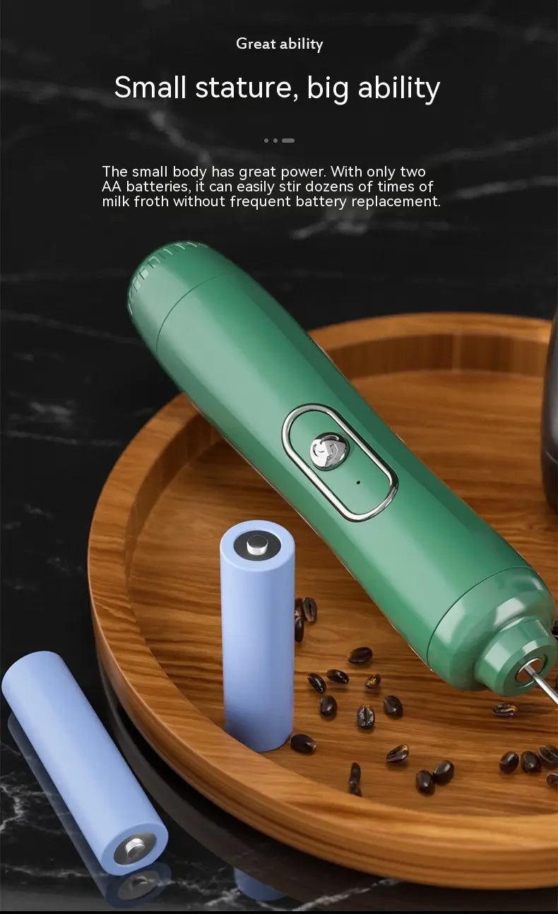 Green handheld battery version milk frother featuring a sleek ergonomic design with a silver accent button for easy frothing.