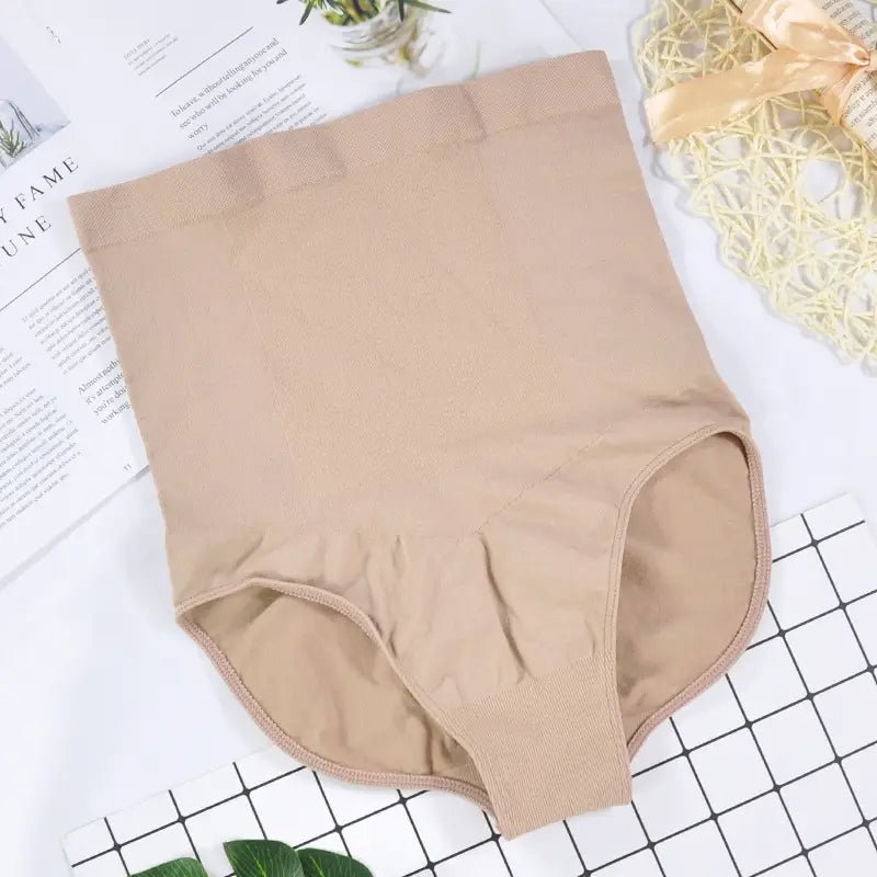 Beige lace high waisted ladies triangle seamless bodysuit with a smooth stretchy fabric finish and seamless waist pants design.