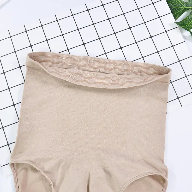 Beige high waisted ladies triangle seamless bodysuit featuring a seamless waist pants design with wavy lace trim at the waistband.