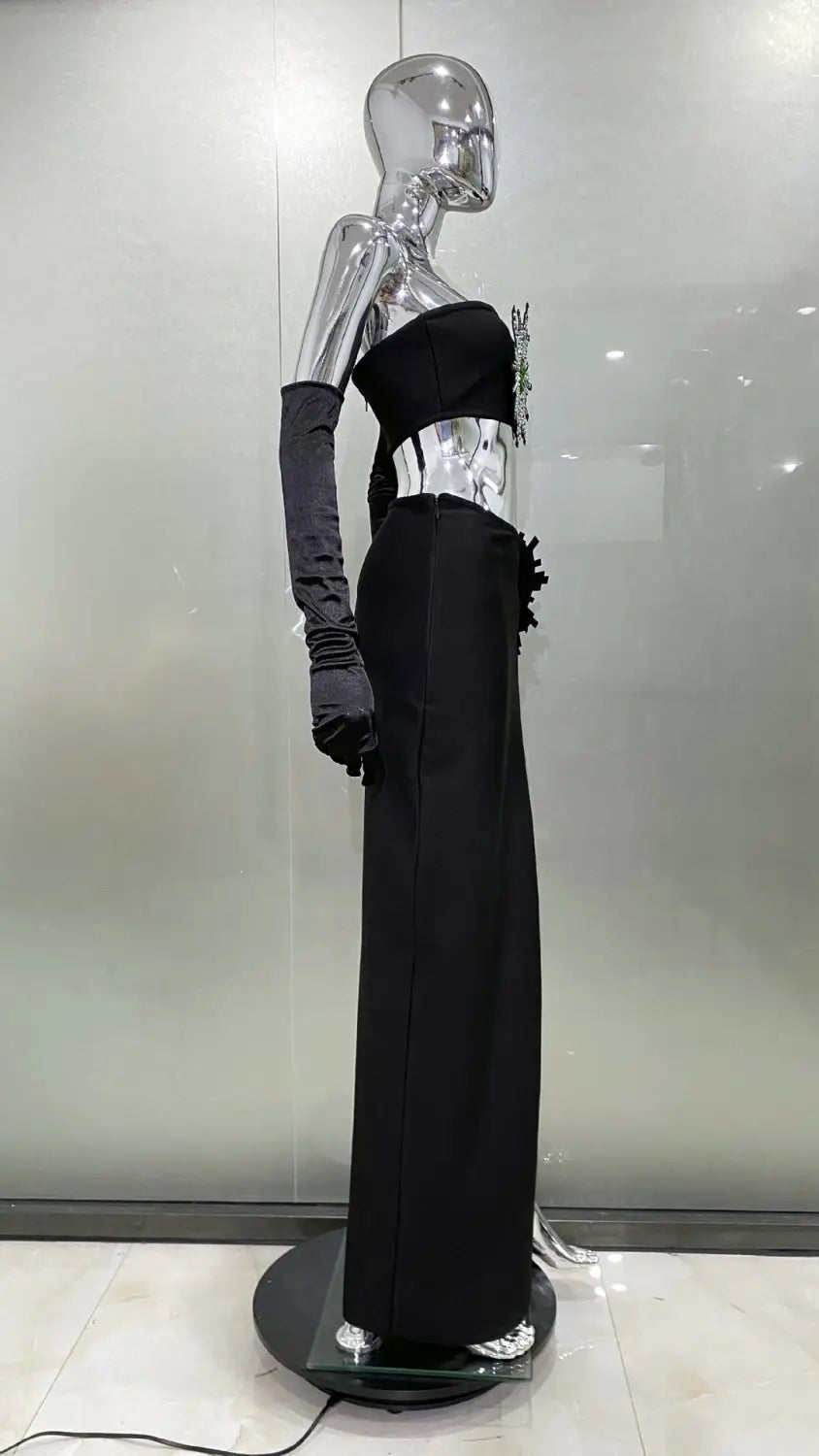 black satin strapless gown with a metallic silver corset detail and ruffled hem featuring a shiny rhinestone tube high slit skirt bandage design