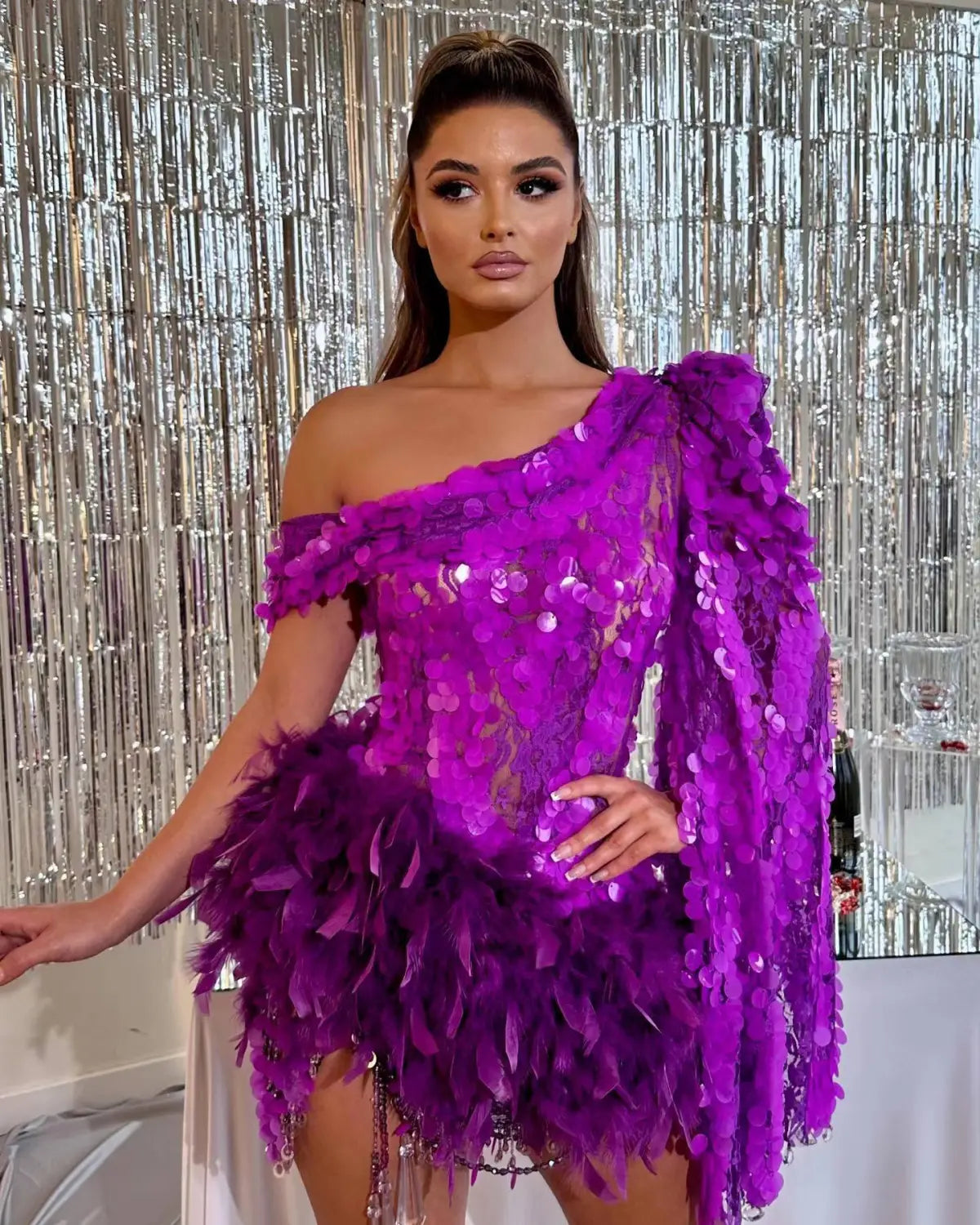 A vibrant purple sequined feather sleeve short dress featuring a one-shoulder design and intricate feather embellishments.