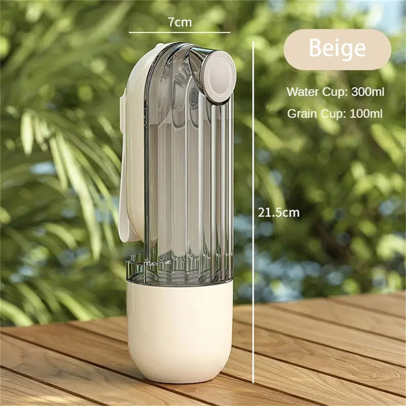 Beige dual-compartment portable green dog walking pet water cup with transparent water cup segment and grain section, 300ml capacity.