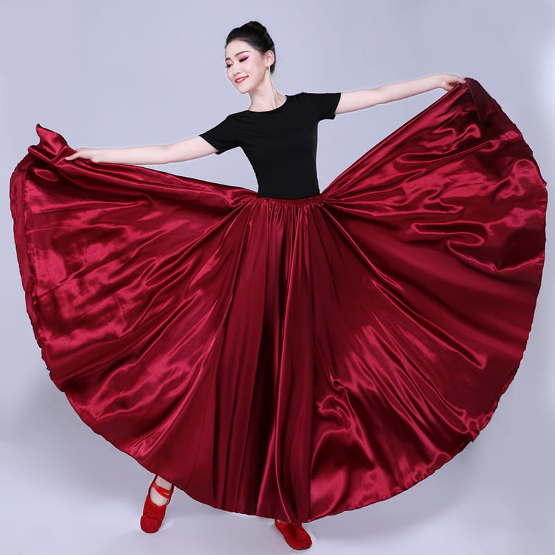 A flowing deep red satin solid color performance skirt with a high-waisted design and wide hem for simple solid color dancewear.