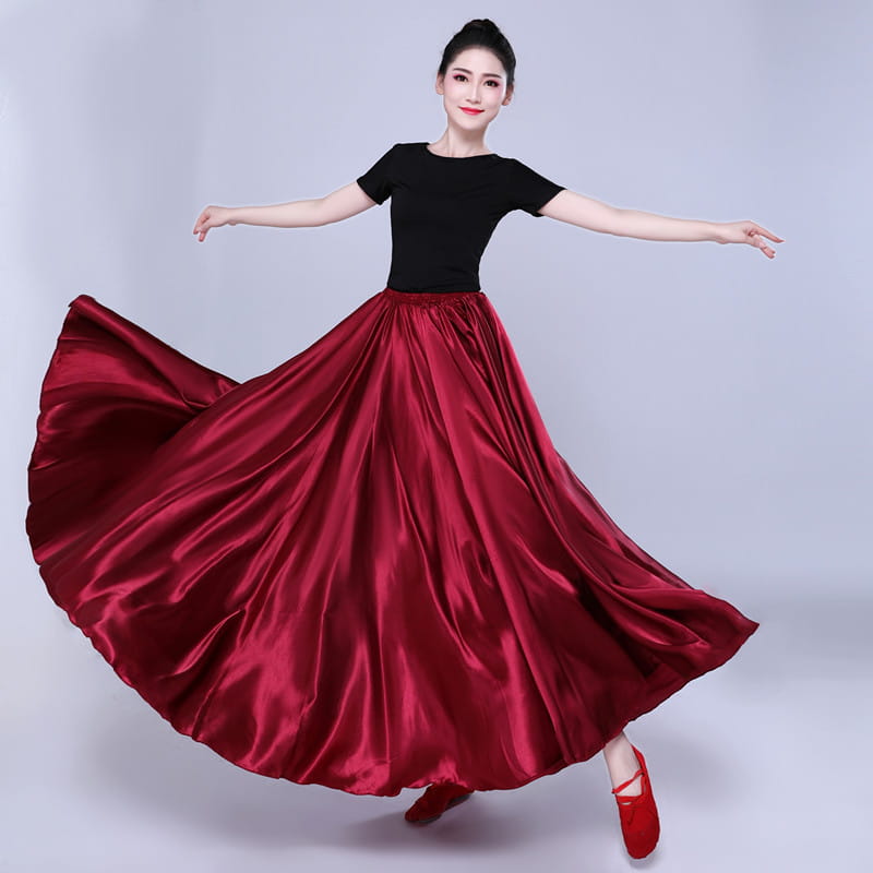 a simple solid color deep red satin dance skirt with a high-waisted design paired with a short black top for solid color performance use