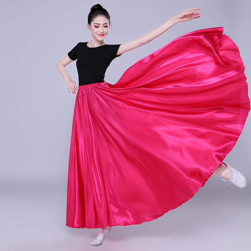 a flowing vibrant pink satin skirt with a high waist and full billowing silhouette designed as a simple solid color performance skirt